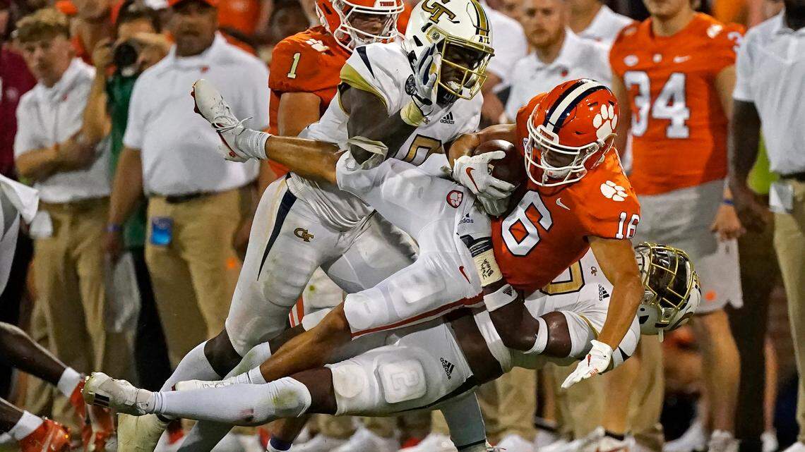Clemson wide receiver E.J. Williams (6) is brought down by Georgia Tech’ Ayinde Eley (10) and Tariq Carpenter (2) after a catch in the second half of an NCAA college football game, Saturday, Sept. 18, 2021, in Clemson, S.C. (AP Photo/John Bazemore)