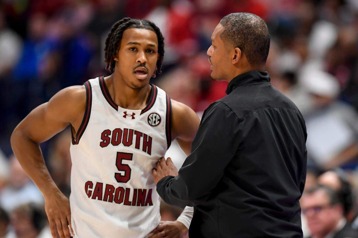 South Carolina Gamecocks head coach Lamont Paris talks with guard Meechie Johnson (5) against the Arkansas Razorbacks during the game Thursday at Bridgestone Arena.