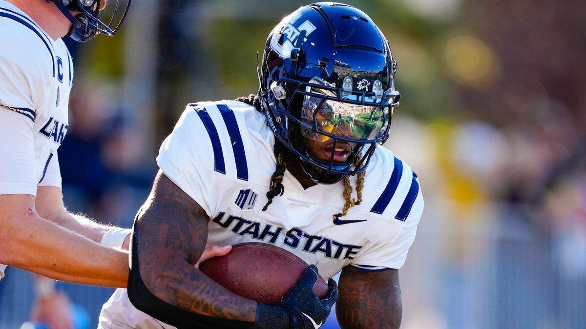Utah State Aggies running back Rahsul Faison (3) warms up before the game against the Wyoming Cowboys at Jonah Field at War Memorial Stadium.