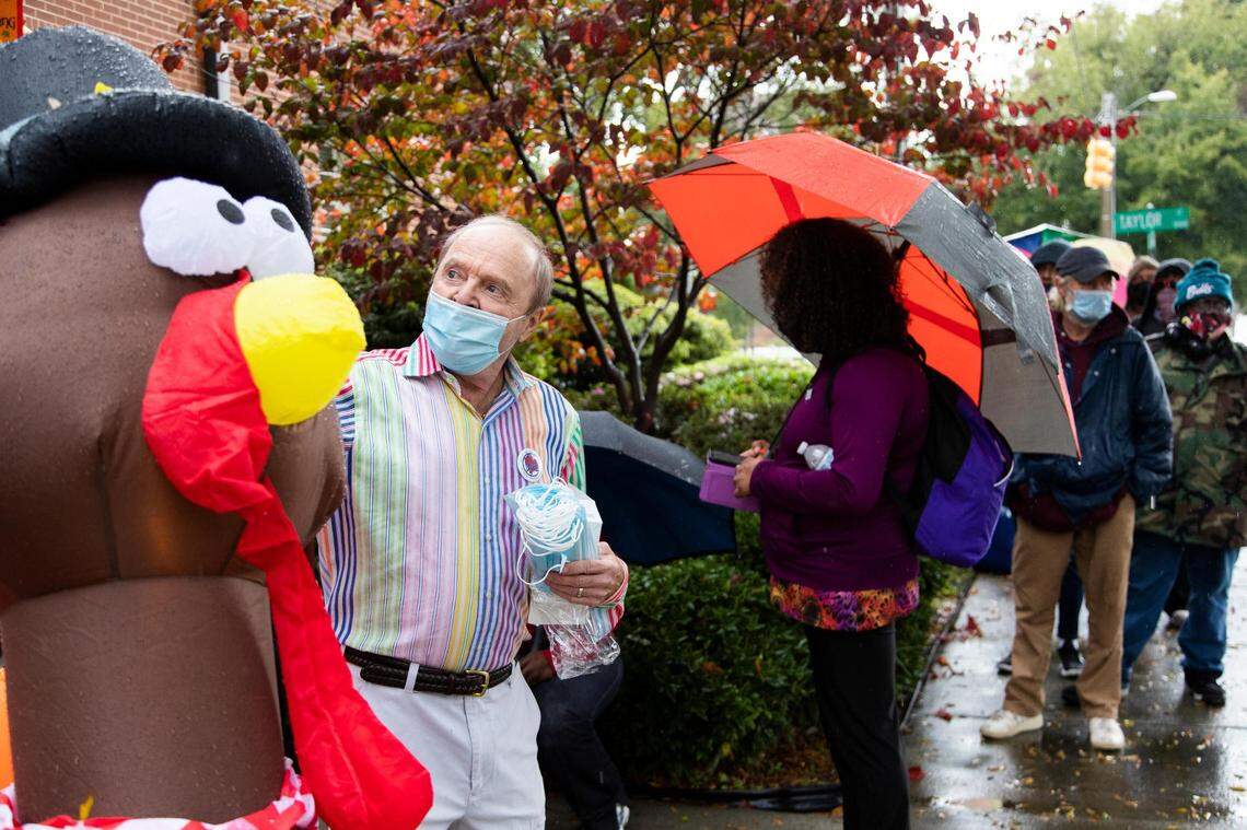 Organizer Robert Keeder inspects rain-soaked decorations at The Basilica of St. Peter in downtown Columbia, South Carolina on Thursday, November 26, 2020. Keeder and other volunteers handed out masks to those waiting in line for a Thanksgiving lunch to go.