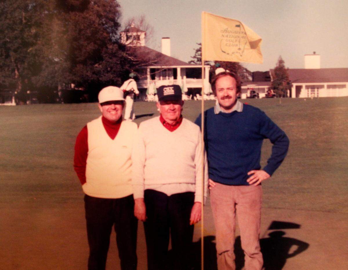 Larry Mattox, left, of Columbia, stands on the 18th green at Augusta National Golf Club in 1987 with his brother Donald, right, and his father Bob.