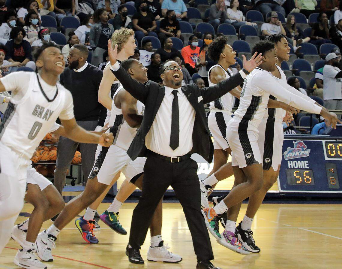 Gray Collegiate basketball coach Dion Bethea celebrates after his team wins the Class 2A state championship game Saturday in Aiken.