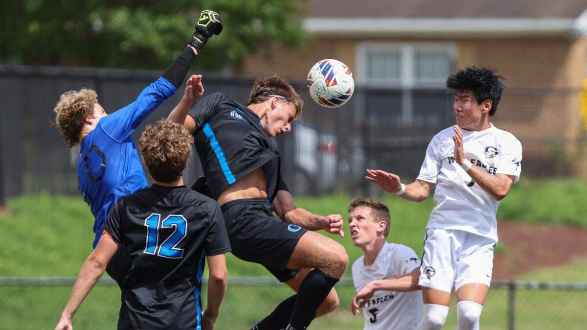Goalie Sean O’Neal (50) of Oceanside Collegiate makes a stop as Jonathan Coonce (7) of Gray Collegiate and Beck Dean (13) of Oceanside Collegiate go up for headers during the SCHSL Class 2A Boys State Soccer Championship between Oceanside Collegiate and Gray Collegiate at Irmo High School on Saturday, May 13, 2023.