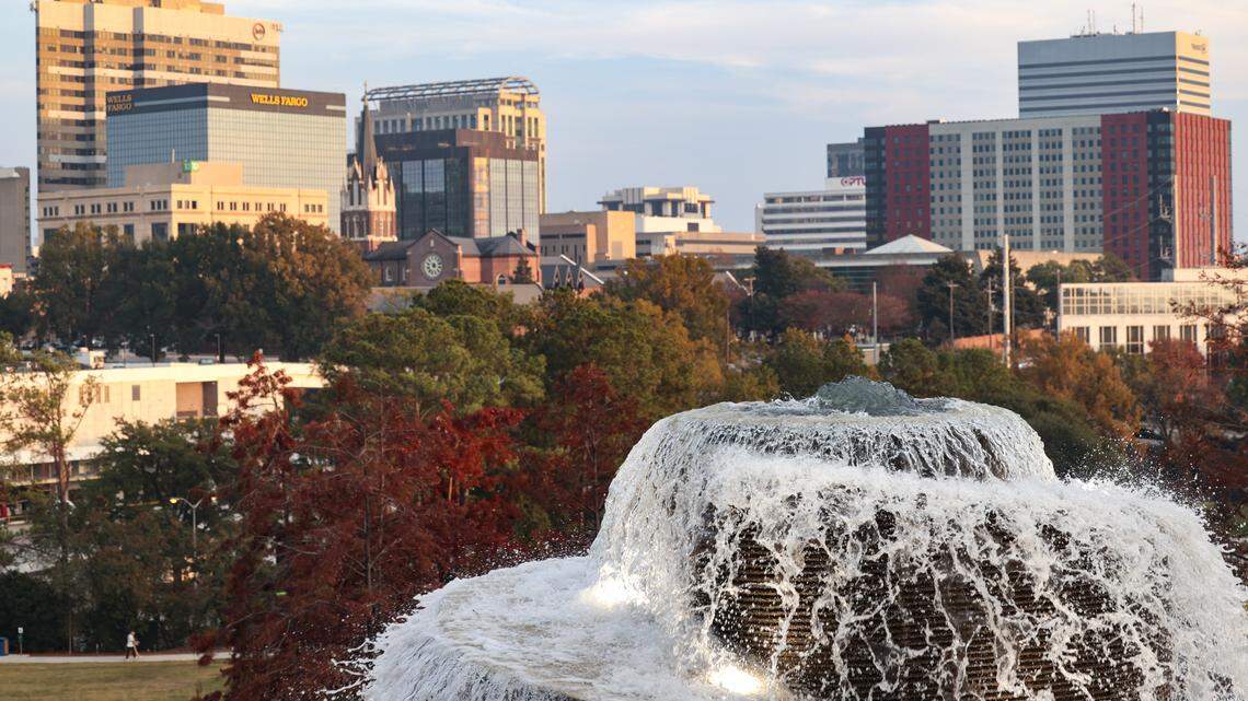 The downtown Columbia skyline shines beyond the fountain at Finlay Park on Thursday, Nov. 20, 2025.