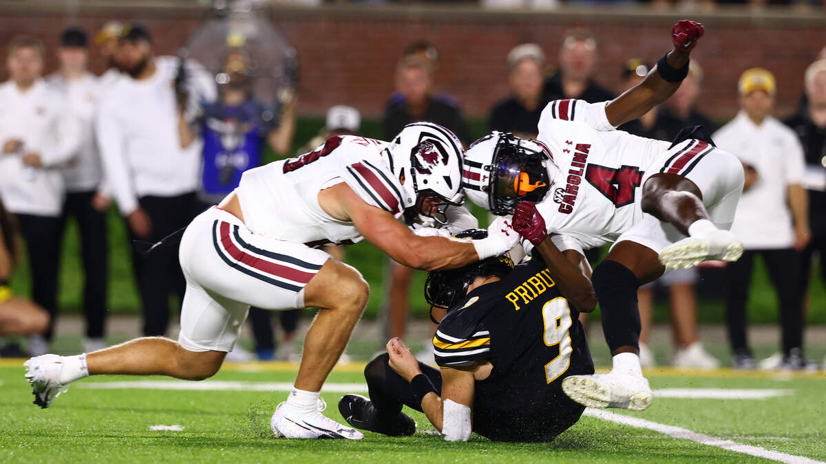 South Carolina defensive back Vicari Swain (4) and defensive back David Bucey (13) tackle Missouri quarterback Beau Pribula during the Gamecocks’ game against Missouri at Memorial Stadium in Columbia, MO on Saturday, September 20, 2025.