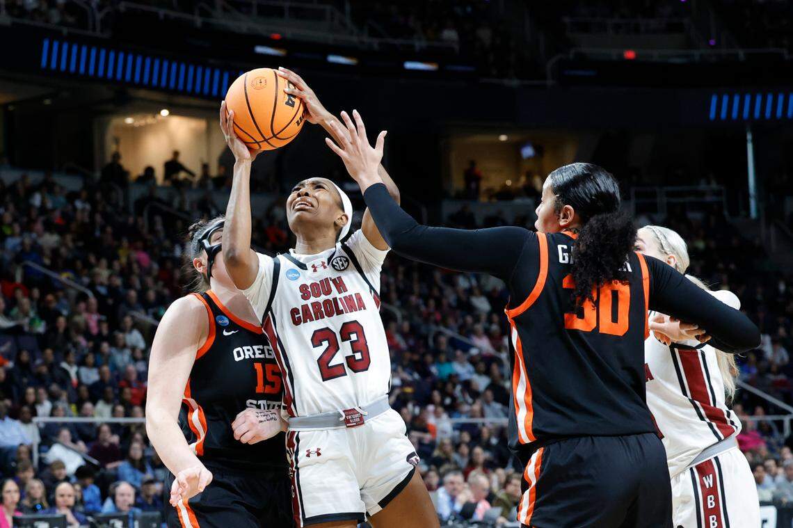 South Carolina’s Bree Hall (23)shoots as Oregon State’s Timea Gardiner (30) and Oregon State’s Raegan Beers (15) pressure during the Elite Eight round of the NCAA Tournament at the MVP Arena in Albany, New York on Sunday, March 31, 2024.