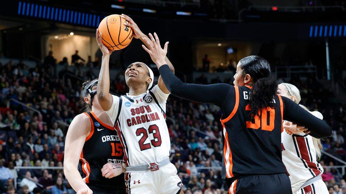 South Carolina’s Bree Hall (23)shoots as Oregon State’s Timea Gardiner (30) and Oregon State’s Raegan Beers (15) pressure during the Elite Eight round of the NCAA Tournament at the MVP Arena in Albany, New York on Sunday, March 31, 2024.