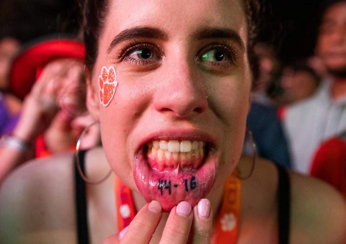 Lyndsey Robison shows her tattoo showing the final score of 2019’s College Football Playoff National Championship in Clemson, South Carolina on Monday, January 13, 2020. She and hundreds of others watched Clemson’s game against LSU on two giant televisions in downtown Clemson.