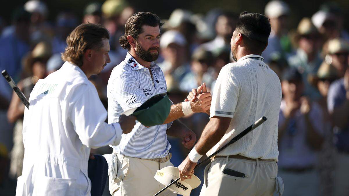 Cameron Young of the United States and Jason Day of Australia shake hands on the 18th green Saturday during the third round of the 2026 Masters Tournament at Augusta National Golf Club.