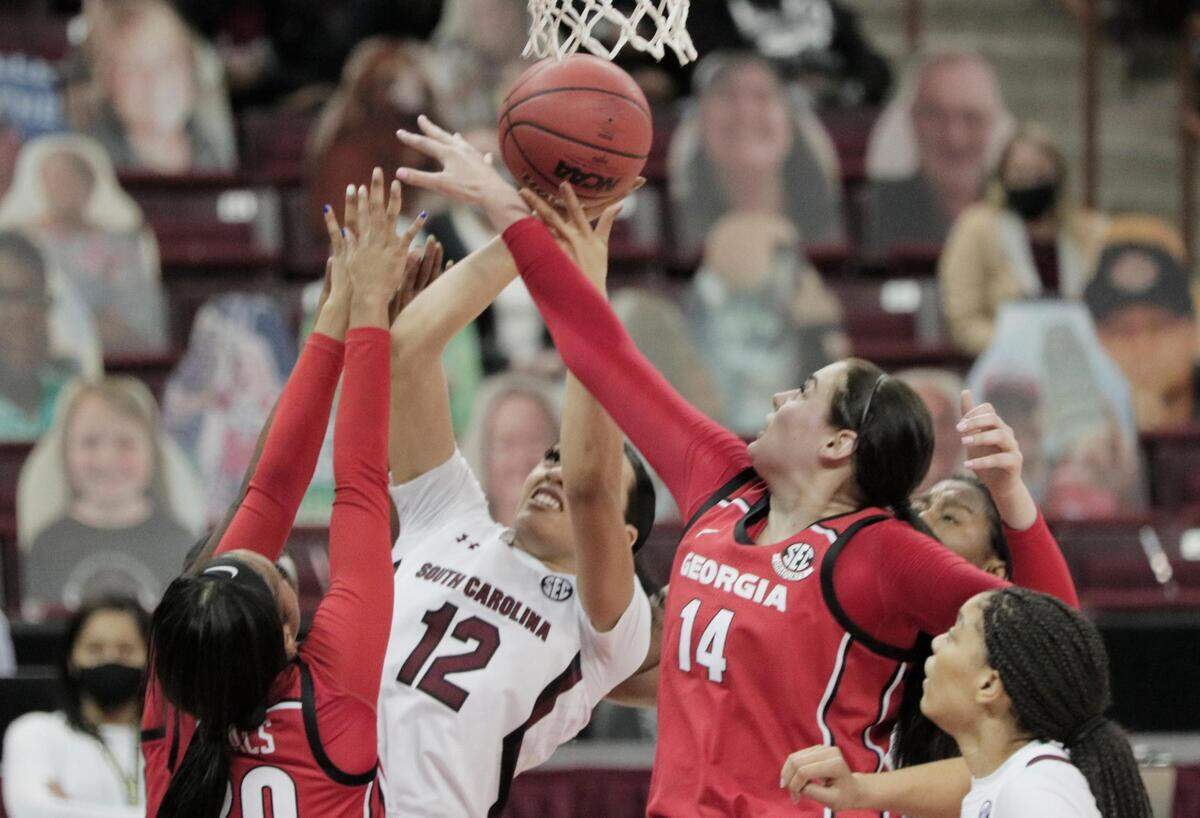 South Carolina Gamecocks guard Brea Beal (12) attempts to shoot as Georgia Lady Bulldogs center Jenna Staiti (14) blocks at Colonial Life Arena on Thursday, January 21, 2021.