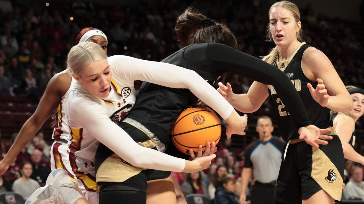 University of South Carolina’s Chloe Kitts (21) wraps up with Wofford’s Evangelia Paulk (3) during the first half of action in the Colonial Life Arena on Sunday, Dec. 29, 2024.