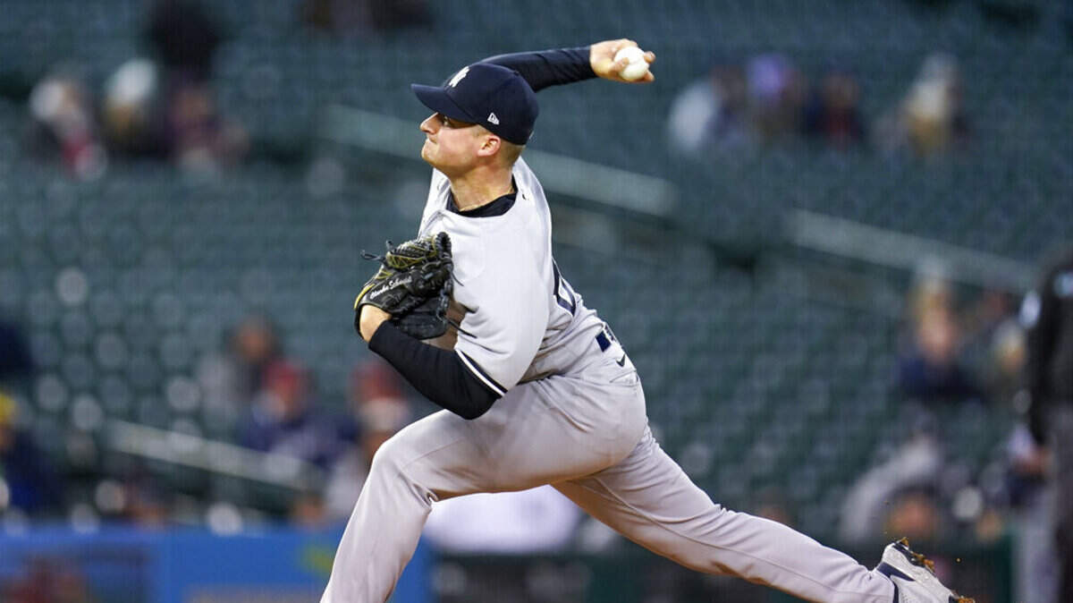 New York Yankees pitcher Clarke Schmidt throws against the Detroit Tigers in the third inning of a baseball game in Detroit, Tuesday, April 19, 2022.