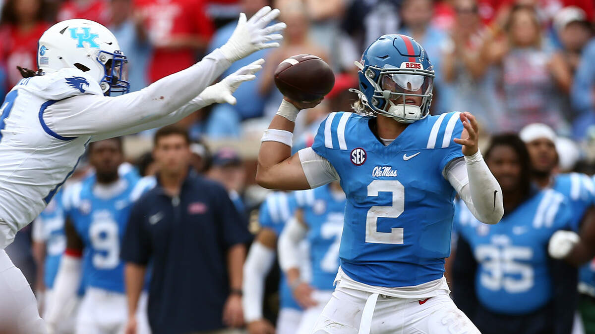 Mississippi Rebels quarterback Jaxson Dart (2) attempts to pass the ball as Kentucky Wildcats linebacker J.J. Weaver (13) rushes during the second half last Saturday at Vaught-Hemingway Stadium.