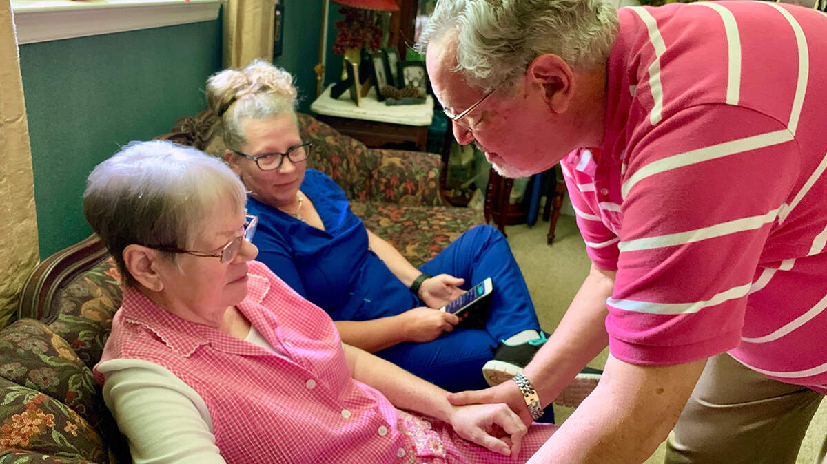 John McCasland of Goodlettsville, Tenn., hired a private caregiver to help with his wife, Jea, left,, who suffered from dementia for eight years. Even when hospice took over, he still found he needed the extra help from Karrie Velez. Jean died in October after 13 months on home hospice. (Blake Farmer/WPLN)