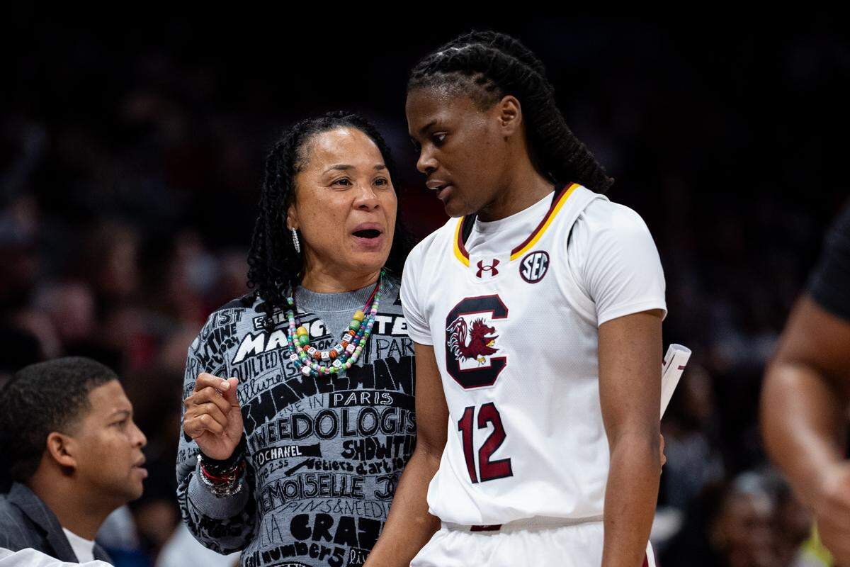 Head coach Dawn Staley of the South Carolina Gamecocks talks with MiLaysia Fulwiley during a November 2024 game against the NC State Wolfpack.
