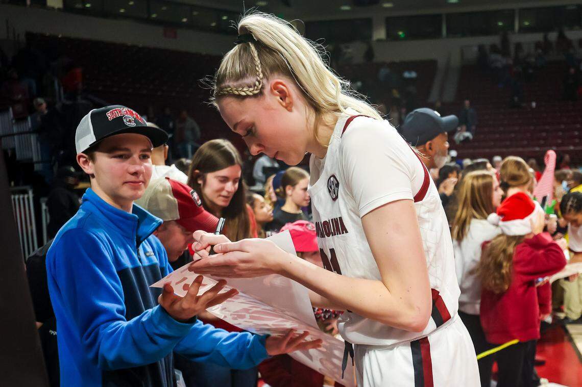 Dec 21, 2022; Columbia, South Carolina, USA; South Carolina Gamecocks forward Chloe Kitts (21) signs autographs following their win over the Coastal Carolina Chanticleers in the second half at Colonial Life Arena. Mandatory Credit: Jeff Blake-USA TODAY Sports