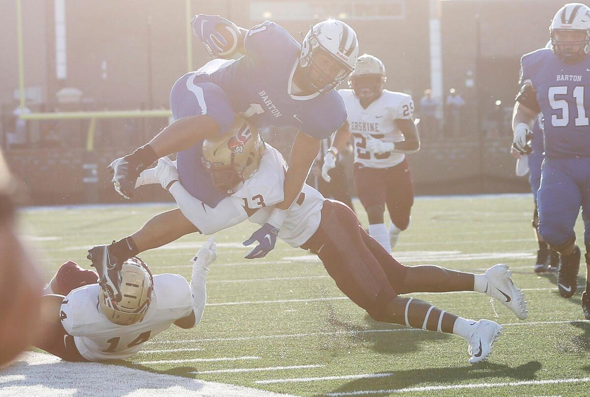 Barton running back Jordan Terrell (1) gets knocked out of bounds by Erskine defensive back Jamal Barron (13) in the fourth quarter.