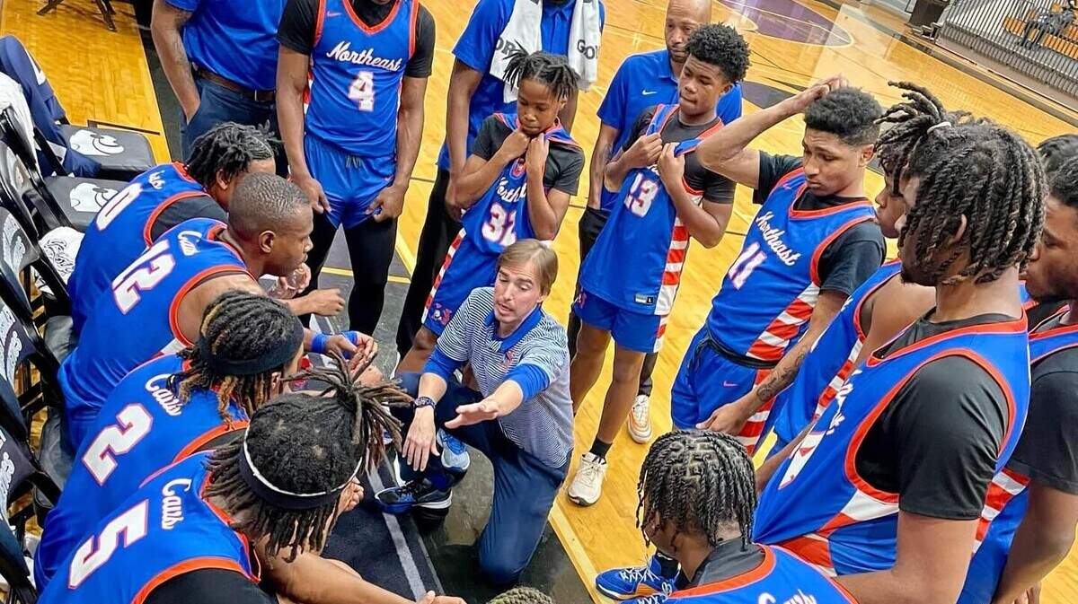 Richland Northeast boys basketball coach Jacob Lourie talks to his team during a game in the 2023-24 season.