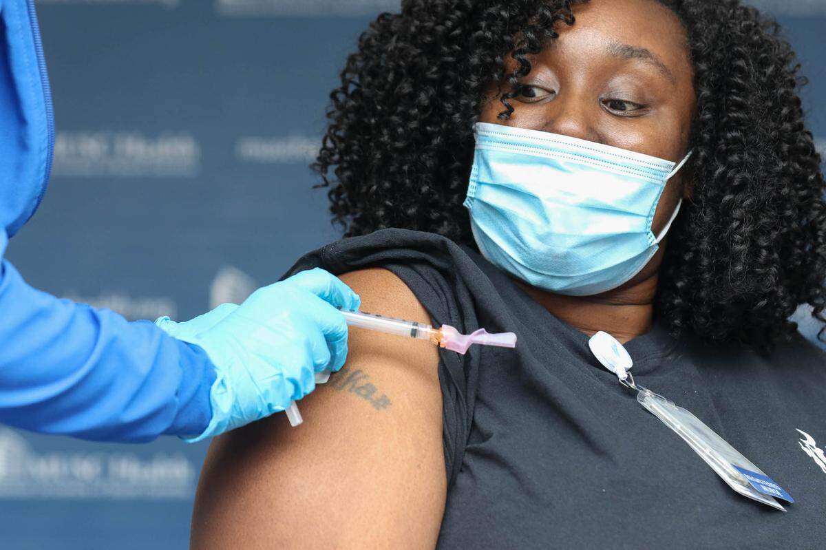 Pediatric nurse Shemika Champion is the first to receive a COVID-19 vaccine at the Medical University of South Carolina in Charleston on Tuesday, Dec. 15, 2020.