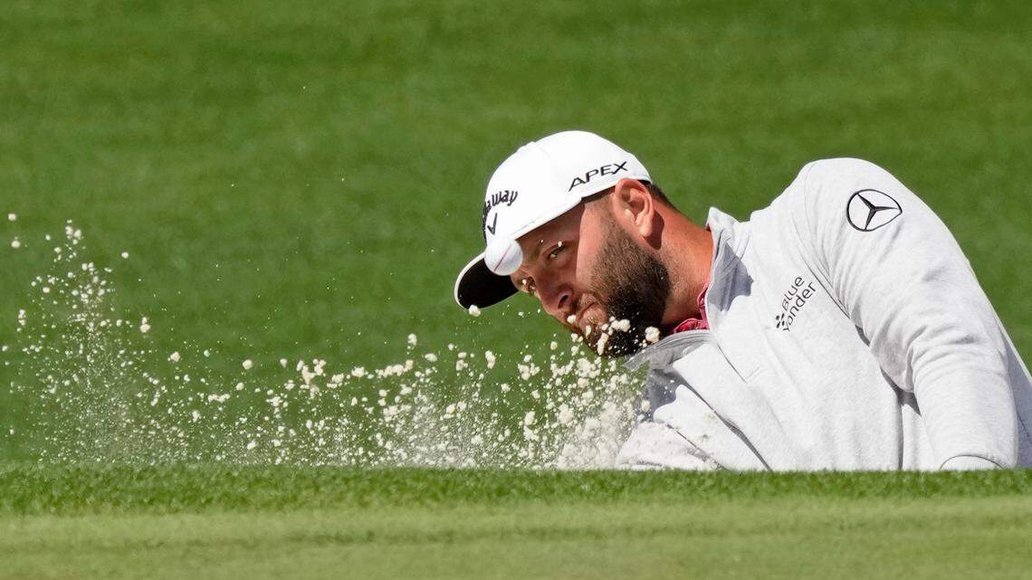 Jon Rahm plays a shot from a bunker on the second hole during the final round of The Masters golf tournament.