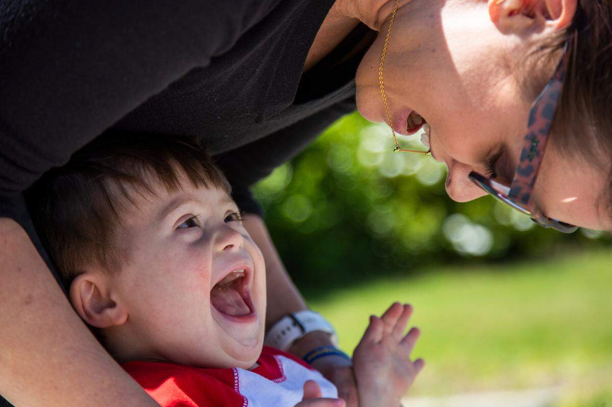 Victor Walsh, 21 months, does physical therapy with the help of his mother Hollis Walsh and physical therapist Lisa Pappas outside his home on Thursday May 7, 2020. Walsh has Down’s Syndrome and low muscle mass for his age. Early intervention therapies are important his longterm health, but have been complicated by the coronavirus.