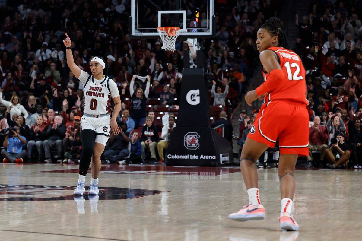 South Carolina’s Te-Hina Paopao (0) celebrates a three-pointer as Georgia’s Taniyah Thompson (12) heads downcourt during the first half of action in the Colonial Life Arena on Sunday, Feb. 18, 2024