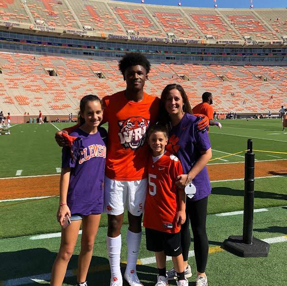 When Tee Higgins was at Clemson, Oak Ridge guidance counselor and head girls basketball coach Paige Taylor (right) would bring her kids, Kannon (left) and Kutler (second from right) Green to games. Higgins’ relationship with Kutler Green began during a trip to the Bahamas for a boys basketball tournament in 2013.