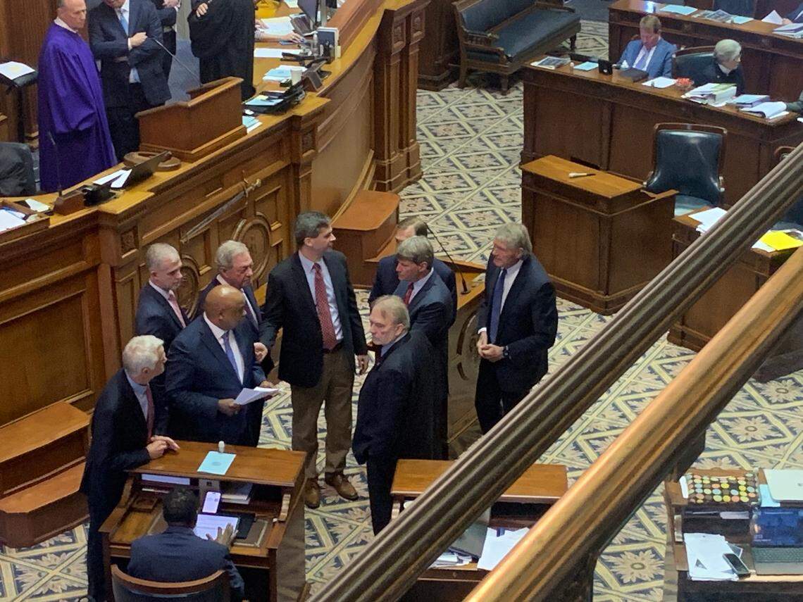 A group of South Carolina state senators huddle on the floor before a vote a judicial reform package on Thursday, March 14, 2024 in Columbia, S.C.