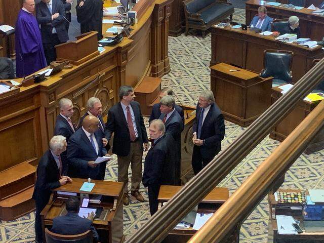 A group of South Carolina state senators huddle on the floor before a vote a judicial reform package on Thursday, March 14, 2024 in Columbia, S.C.