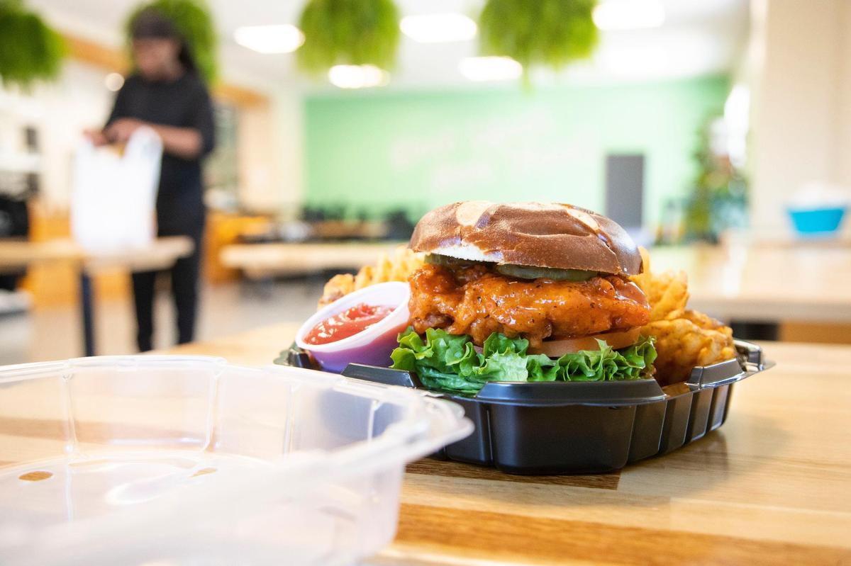 To go orders are set out for customer at A Piece of Soul Vegan Kitchen, on Friday, February 25, 2022. The vegan restaurant makes plant-based versions of popular soul food, including this Nashville style “chicken” sandwich.