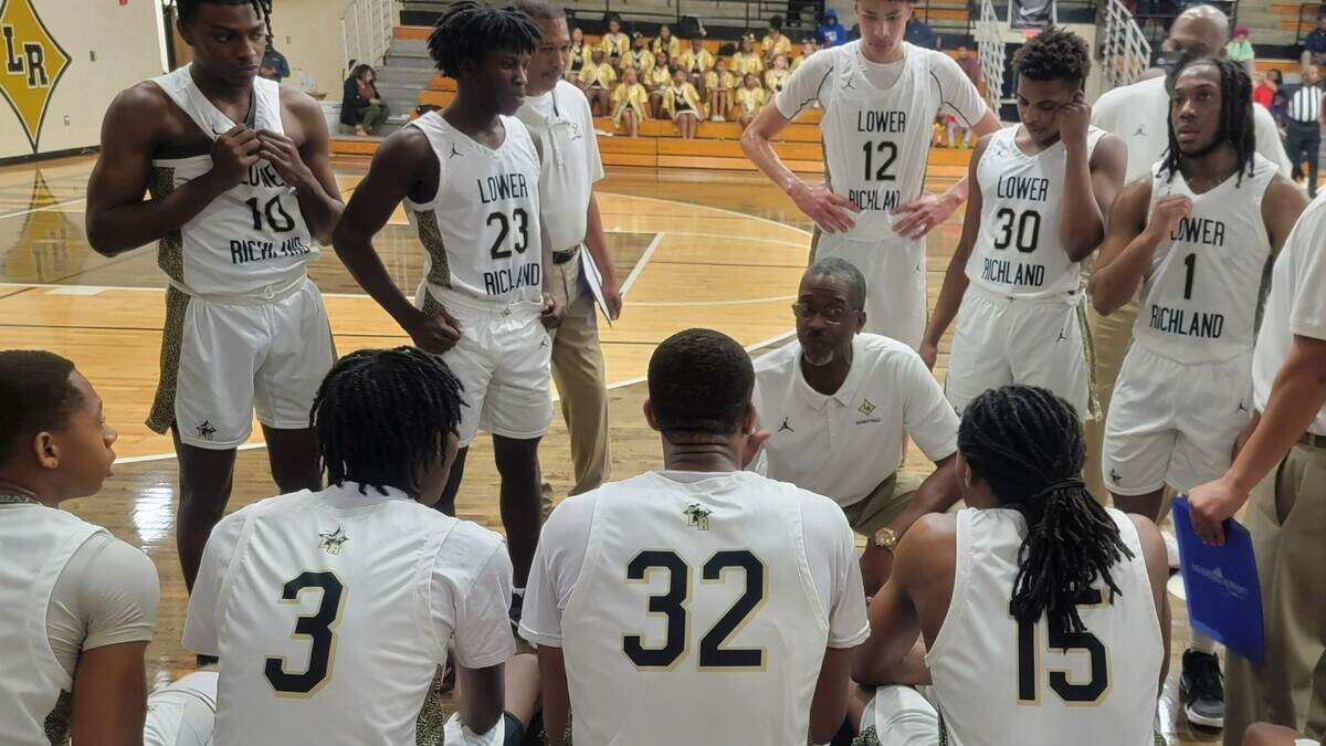 Lower Richland coach Jojo English talks to his team during a timeout of the Class 3A playoff game against North Central on Wednesday, Feb. 15, 2023.