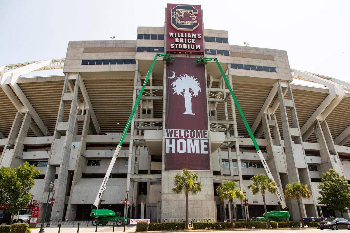 A new banner is placed at Williams-Brice Stadium on Saturday, July 24, 2021. The new banner says “welcome home” and features a palmetto tree and crescent moon in the University of South Carolina’s school colors.