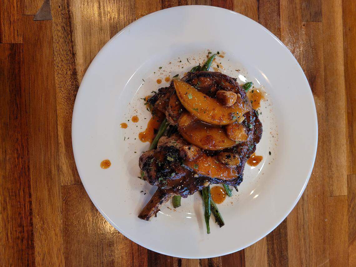 Peach glazed bone in pork chop from Whiskey Kitchen, a new Southern food restaurant on Two Notch Road in Columbia.