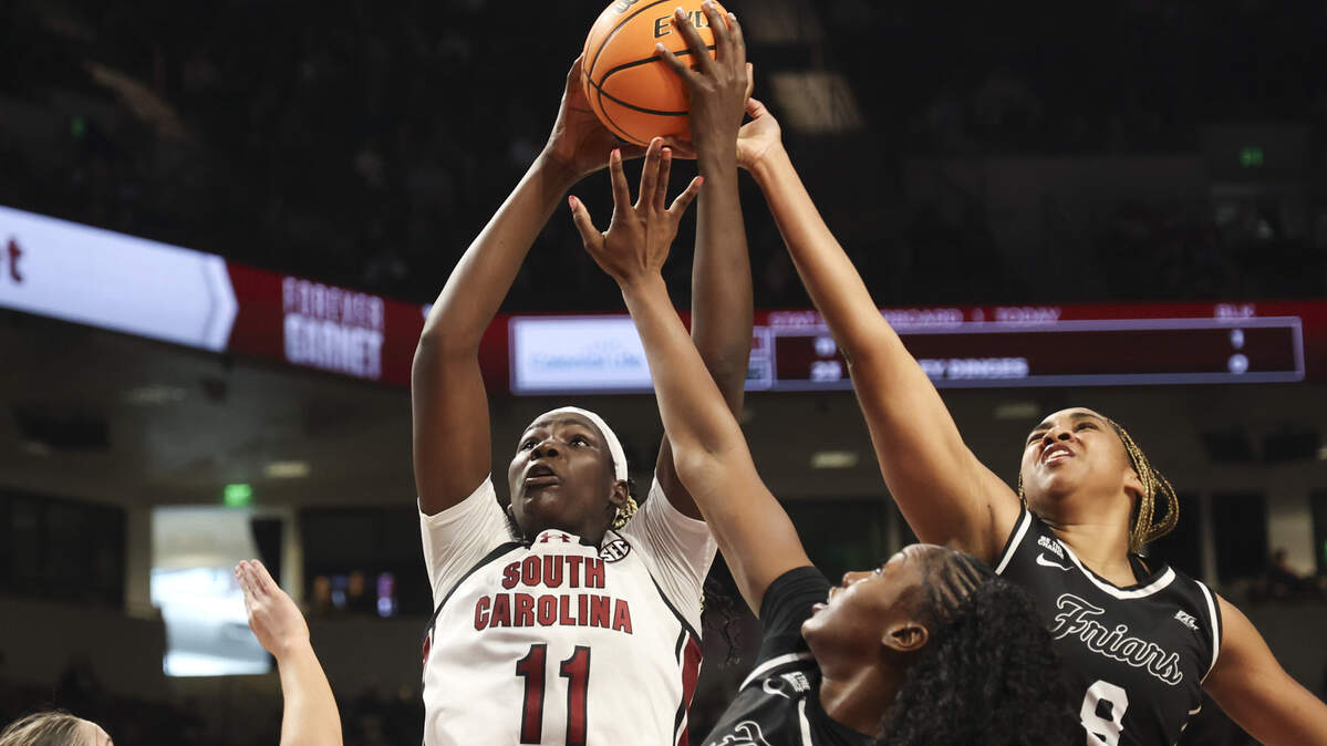 South Carolina's Madina Okot (11) looks to shoot as Providence College's Teneisia Brown (20) and Nalani Kaysia (8) pressure during the first half of action of their women's basketball game against Providence at Colonial Life Arena on Sunday, Dec. 28, 2025.