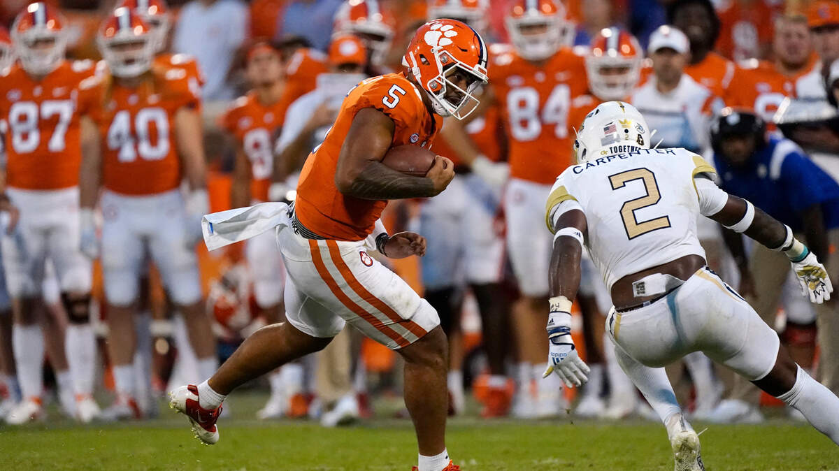 Clemson quarterback D.J. Uiagalelei (5) tries to get past Georgia Tech defensive back Tariq Carpenter (2) in the second half of an NCAA college football game Saturday, Sept. 18, 2021, in Clemson, S.C. (AP Photo/John Bazemore)