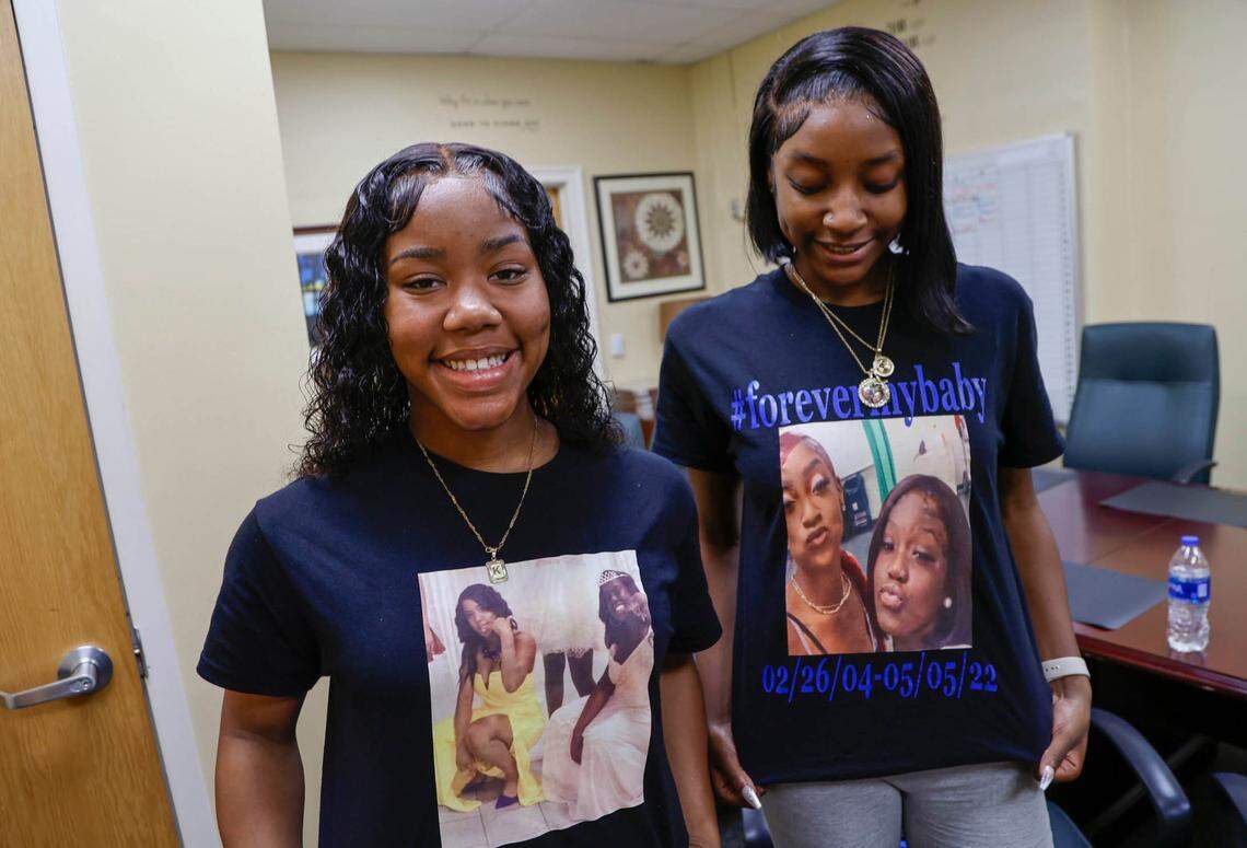 Khamiyah Smalls, left, and Jada Teasley show the shirts they made with photographs of their friend, Sha’Neal Brown, who was one of two seniors at Eau Claire High School who recently died.