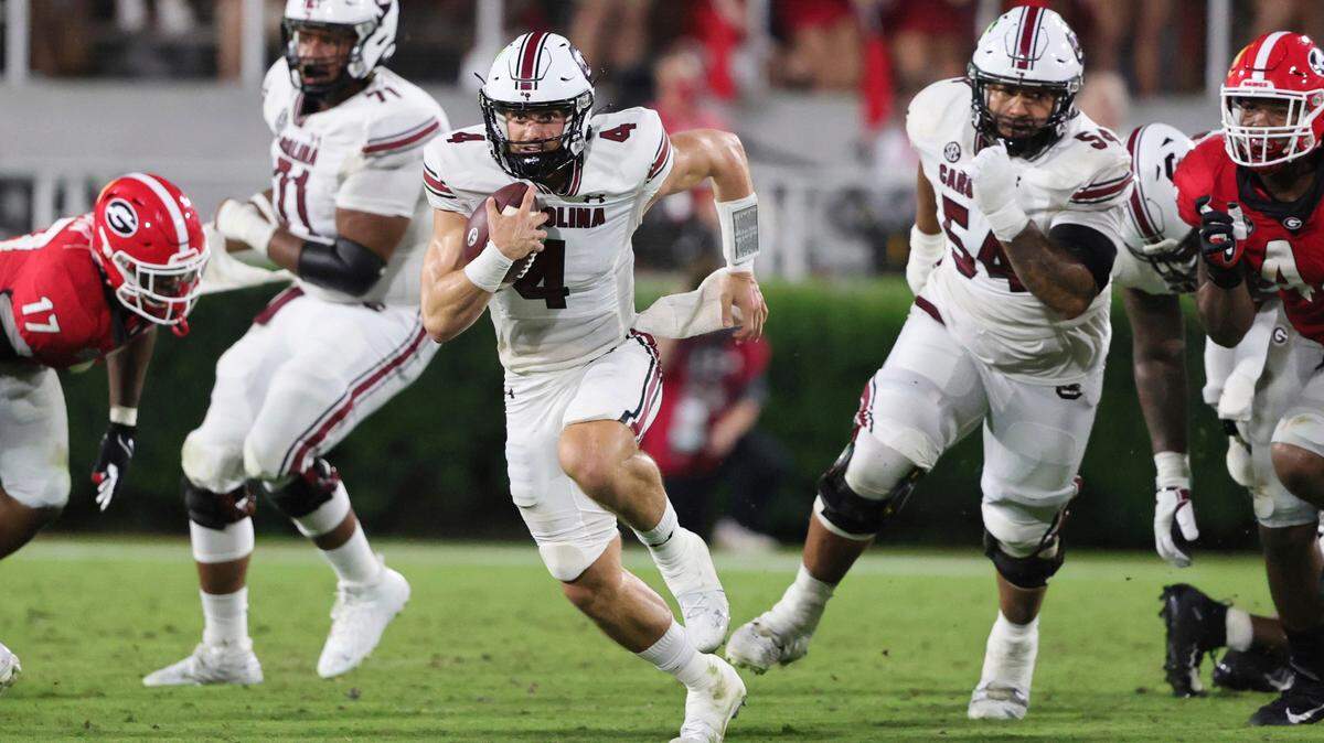 South Carolina quarterback Luke Doty (4) carries the ball against Georgia during the first half of an NCAA college football game Saturday, Sept. 18, 2021, in Athens, Ga. (AP Photo/Butch Dill)