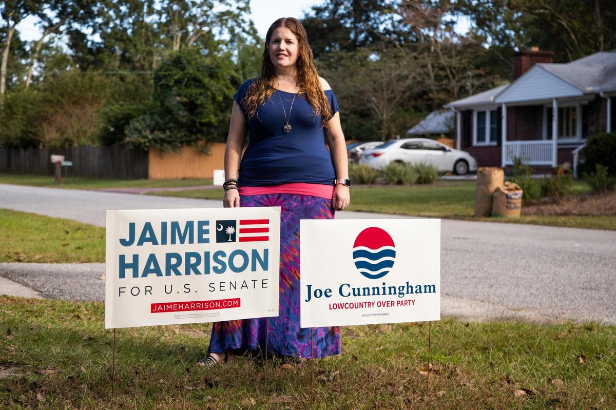 Shannon Robinson, who lives across the street from Congressman Joe Cunningham, poses for a portrait with her yard signs on Friday, October 23, 2020. She normally does not put out yard signs, but after seeing the multiple signs supporting Cunningham’s Republican opponent Nancy Mace, she felt she had to show support for her neighbor.