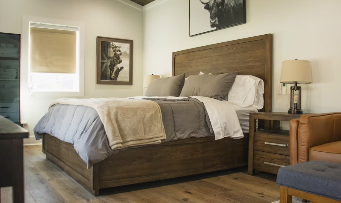 The Farmhouse overlooks a pond with a beach.