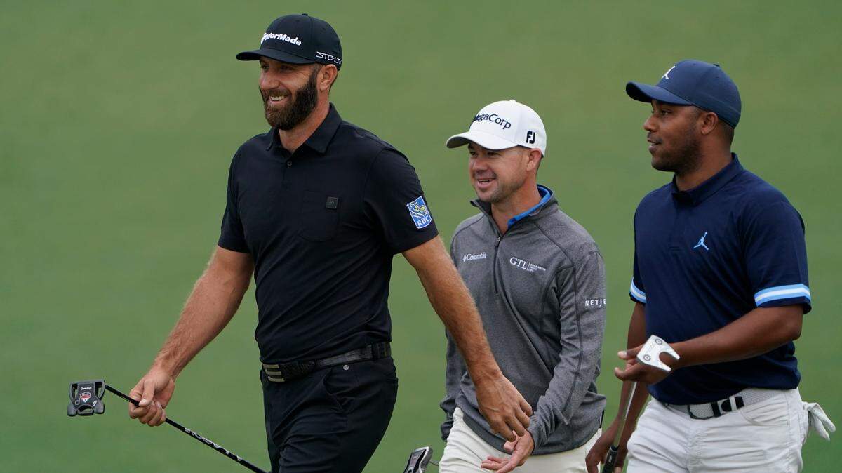 From left, Dustin Johnson, Brian Harman and Harold Varner III walk off the second green during a practice round for the Masters golf tournament on Tuesday, April 5, 2022, in Augusta, Ga. (AP Photo/Jae C. Hong)