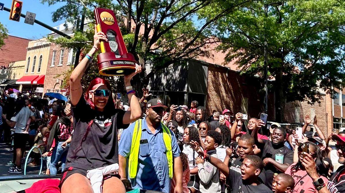 The city of Columbia holds a parade on Main Street to honor the South Carolina women’s basketball team’s 2024 national championship. Here, Kamilla Cardoso holds up the championship trophy.