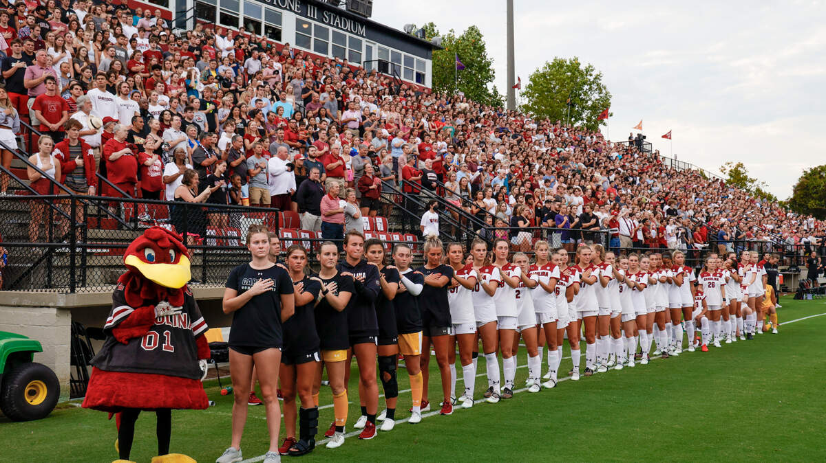 The University of South Carolina women’s soccer team gathers on field before playing Florida State University at Eugene Stone Stadium on Thursday, Aug. 18, 2022