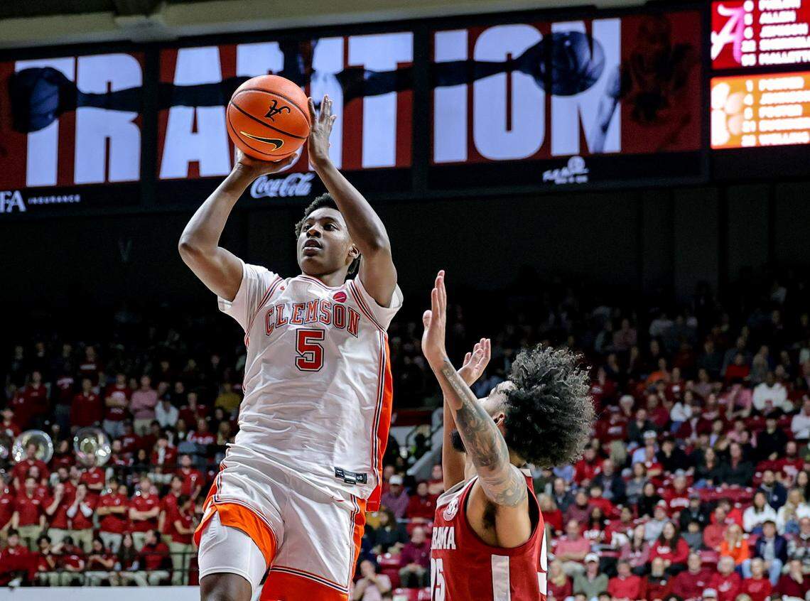 TUSCALOOSA, ALABAMA - DECEMBER 3: Zac Foster #5 of the Clemson Tigers drives to the basket over Houston Mallette #95 of the Alabama Crimson Tide during the first half at Coleman Coliseum on December 3, 2025 in Tuscaloosa, Alabama.