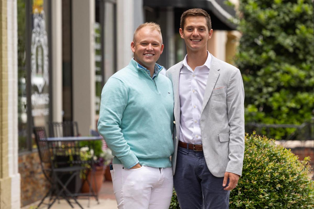 Lexington town council member Gavin Smith poses for a portrait with his husband Matthew Smith in downtown Lexington, South Carolina on Friday, May 26, 2023. Gavin is Lexington’s town council first gay and out elected official.