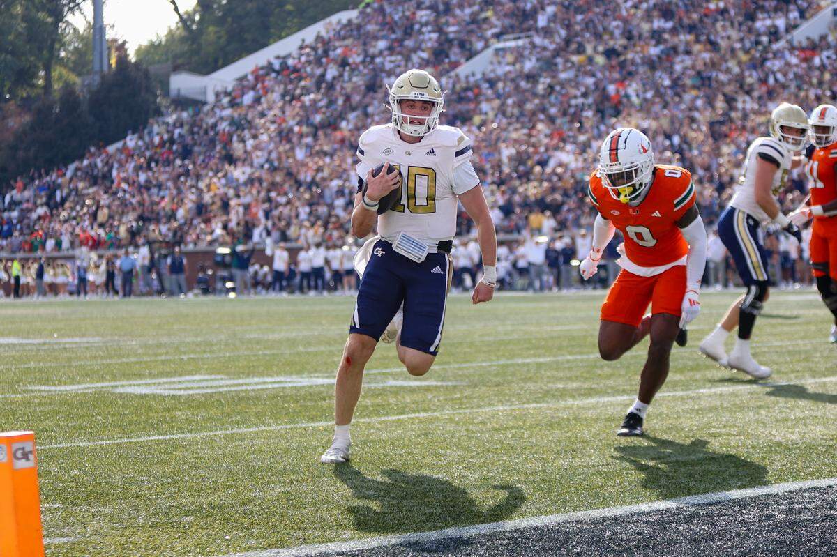 Nov 9, 2024; Atlanta, Georgia, USA; Georgia Tech Yellow Jackets quarterback Haynes King (10) runs for a touchdown against the Miami Hurricanes in the fourth quarter at Bobby Dodd Stadium at Hyundai Field.