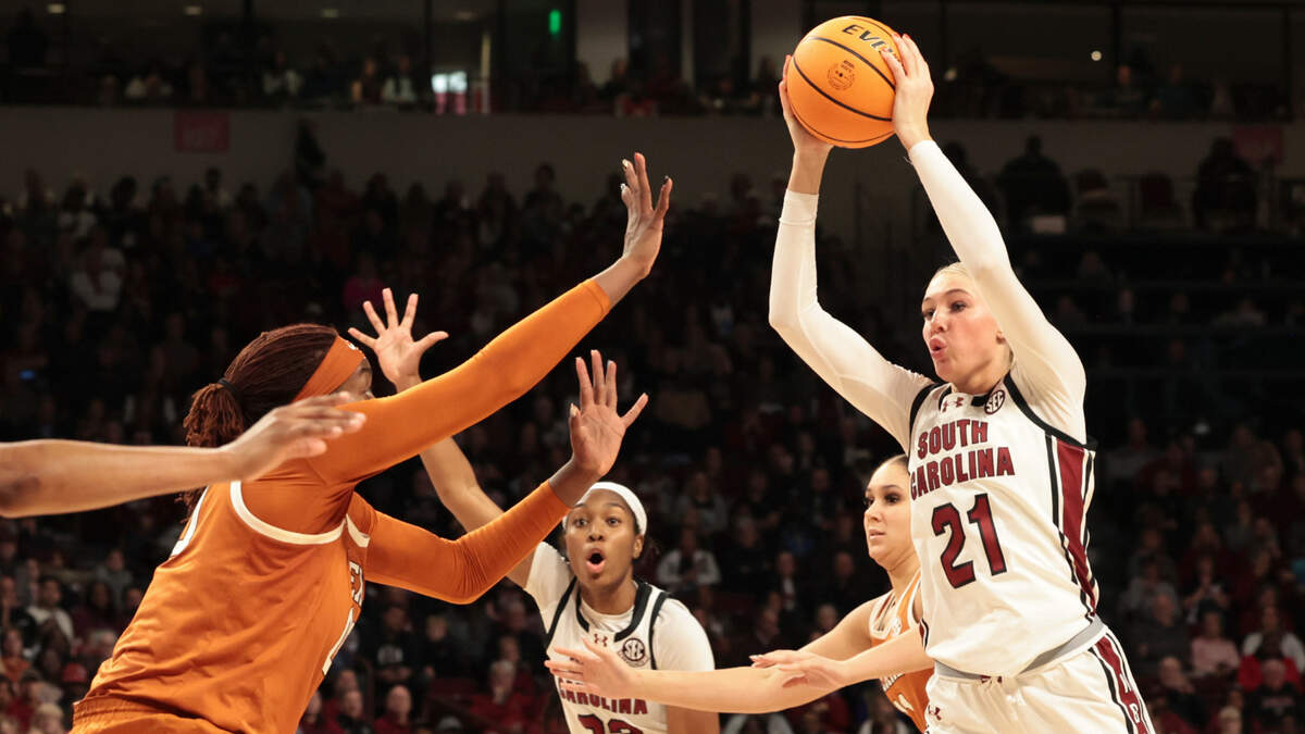 University of South Carolina’s Chloe Kitts (21) is pressured by Texas’ Kyla Oldacre (00) during the second half of action in the Colonial Life Arena on Sunday, Jan. 12, 2025. The Gamecocks won 67-50.