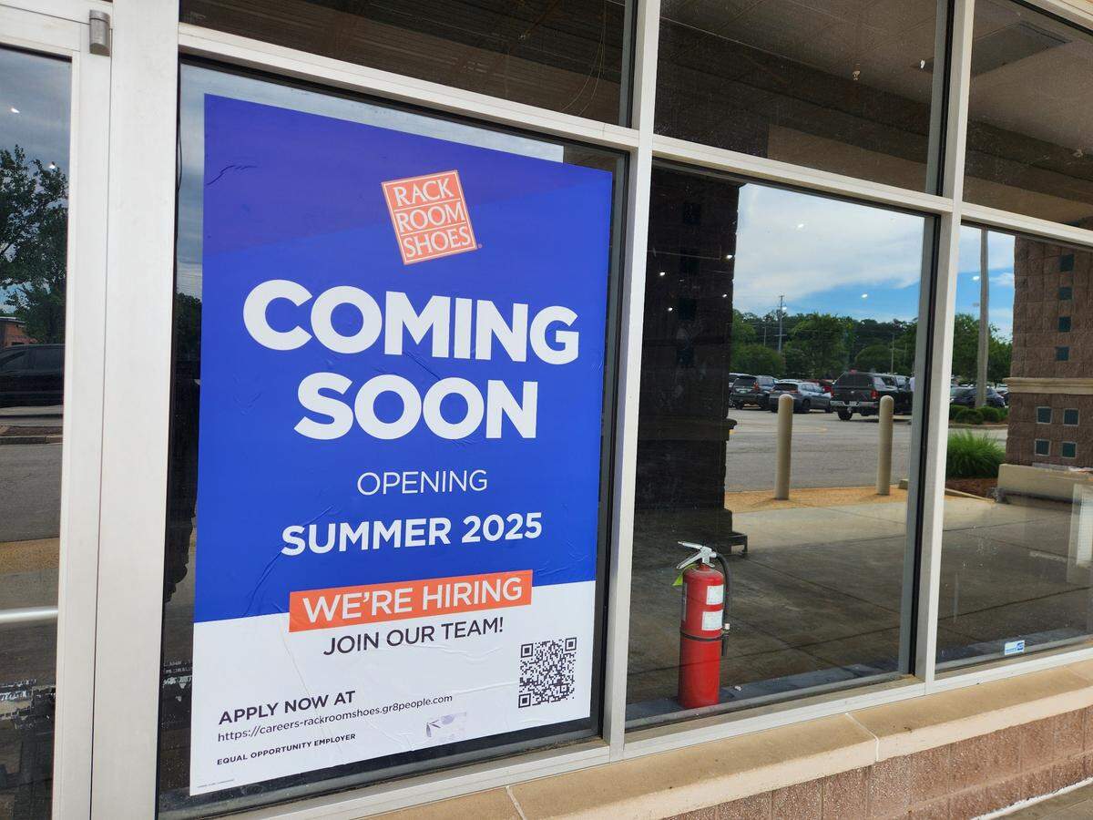 A banner announces that Rack Room Shoes is coming soon at 144 Harbison Blvd. at Columbiana Station shopping center.