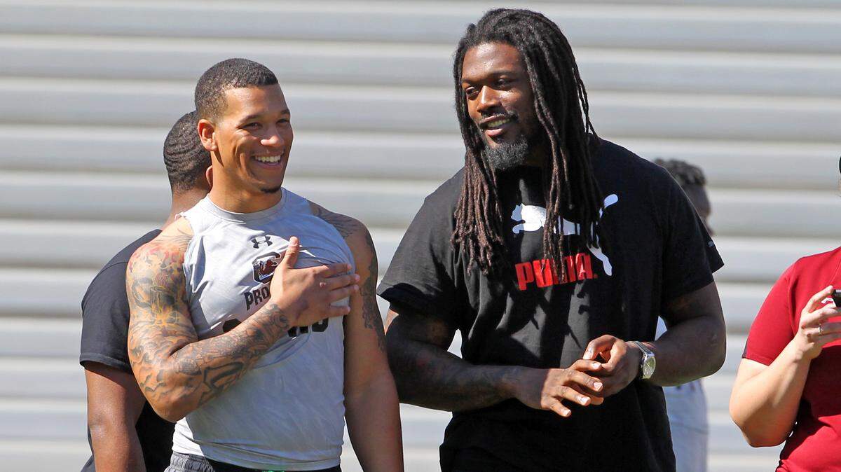 South Carolina Gamecocks running back Brandon Wilds (22) laughs with former Gamecock standout Jadeveon Clowney during USC Pro Day at Williams-Brice Stadium, Wednesday, March 30, 2016.