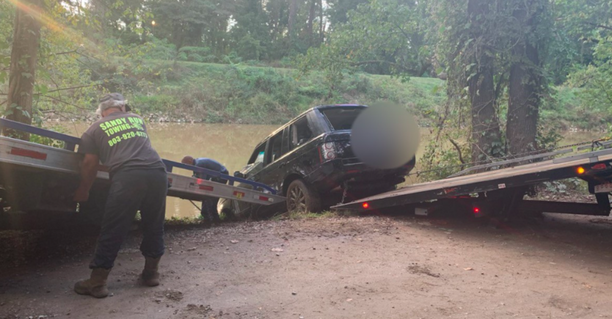 A wrecker service pulls an SUV from the Columbia Canal near River Drive.