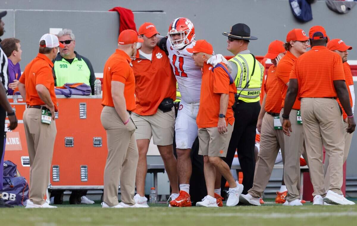 Clemson defensive lineman Bryan Bresee (11) is helped after being injured during N.C. States 27-21 overtime victory over Clemson at Carter-Finley Stadium in Raleigh, N.C., Saturday, Sept. 25, 2021.